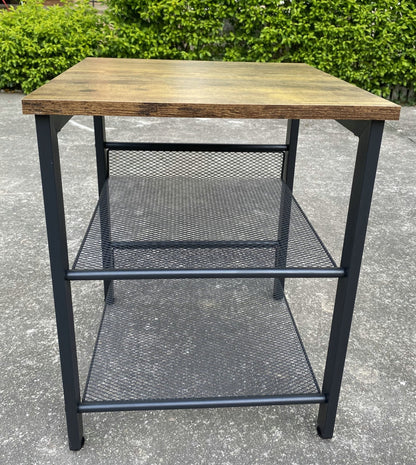 Rustic end tables in a cozy living room setting with sofa and lamp

Side View: Square wood top table with black mesh shelf

Angled View: Rustic wood and black metal table with adjustable shelf

Front View: Front profile of industrial end table with wood top and mesh shelf

Top View: Close-up of wood grain tabletop with rounded edges