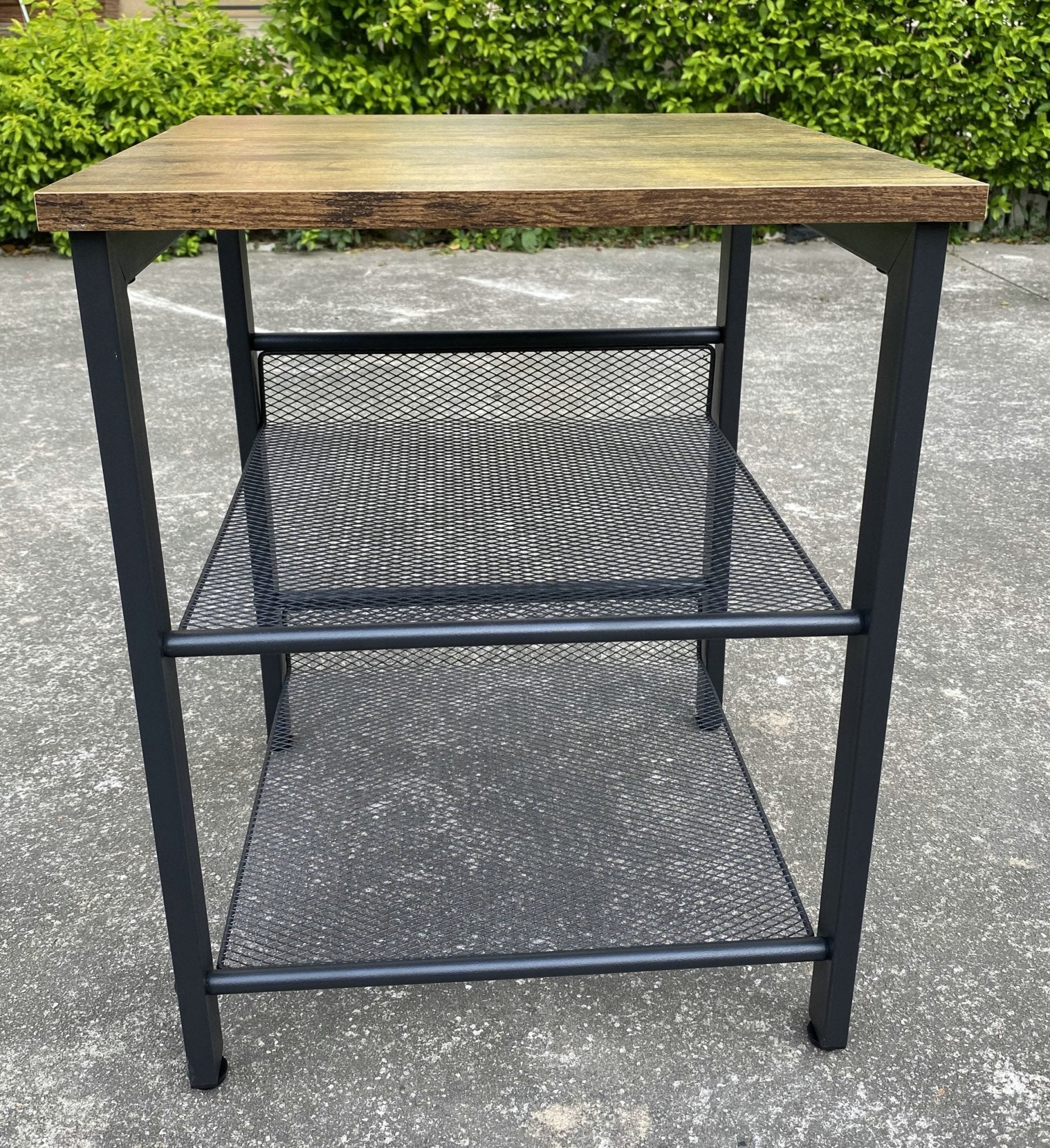 Rustic end tables in a cozy living room setting with sofa and lamp

Side View: Square wood top table with black mesh shelf

Angled View: Rustic wood and black metal table with adjustable shelf

Front View: Front profile of industrial end table with wood top and mesh shelf

Top View: Close-up of wood grain tabletop with rounded edges