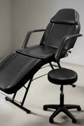 Salon bed adjusted upright as barber or esthetician chair

