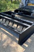 Skid Steer 72" Hydraulic Box Blade Leveler side view
Box grader with hydraulic rippers engaged
Attachment leveling gravel with skid steer
Close-up of pillow block bearings and rippers
Fully mounted box blade in action