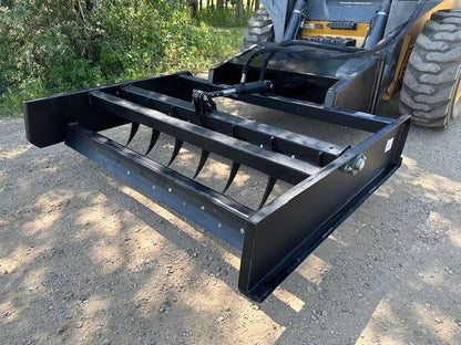 Skid Steer 72" Hydraulic Box Blade Leveler side view
Box grader with hydraulic rippers engaged
Attachment leveling gravel with skid steer
Close-up of pillow block bearings and rippers
Fully mounted box blade in action