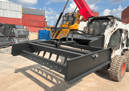 Skid Steer 72" Hydraulic Box Blade Leveler side view
Box grader with hydraulic rippers engaged
Attachment leveling gravel with skid steer
Close-up of pillow block bearings and rippers
Fully mounted box blade in action