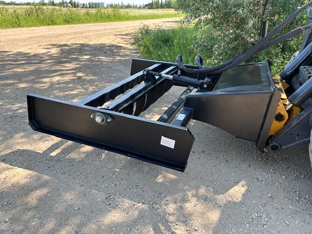 Skid Steer 72" Hydraulic Box Blade Leveler side view
Box grader with hydraulic rippers engaged
Attachment leveling gravel with skid steer
Close-up of pillow block bearings and rippers
Fully mounted box blade in action