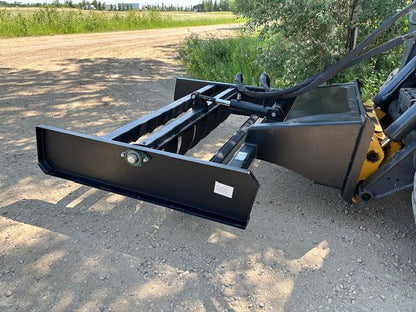 Skid Steer 72" Hydraulic Box Blade Leveler side view
Box grader with hydraulic rippers engaged
Attachment leveling gravel with skid steer
Close-up of pillow block bearings and rippers
Fully mounted box blade in action