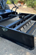 Skid Steer 72" Hydraulic Box Blade Leveler side view
Box grader with hydraulic rippers engaged
Attachment leveling gravel with skid steer
Close-up of pillow block bearings and rippers
Fully mounted box blade in action