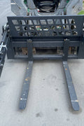 Front view of skid steer pipe grapple with clamp arms
Side view showing 48-inch clamp arm forks in use
Pipe grapple lifting construction material
Close-up of dual hydraulic clamp system
