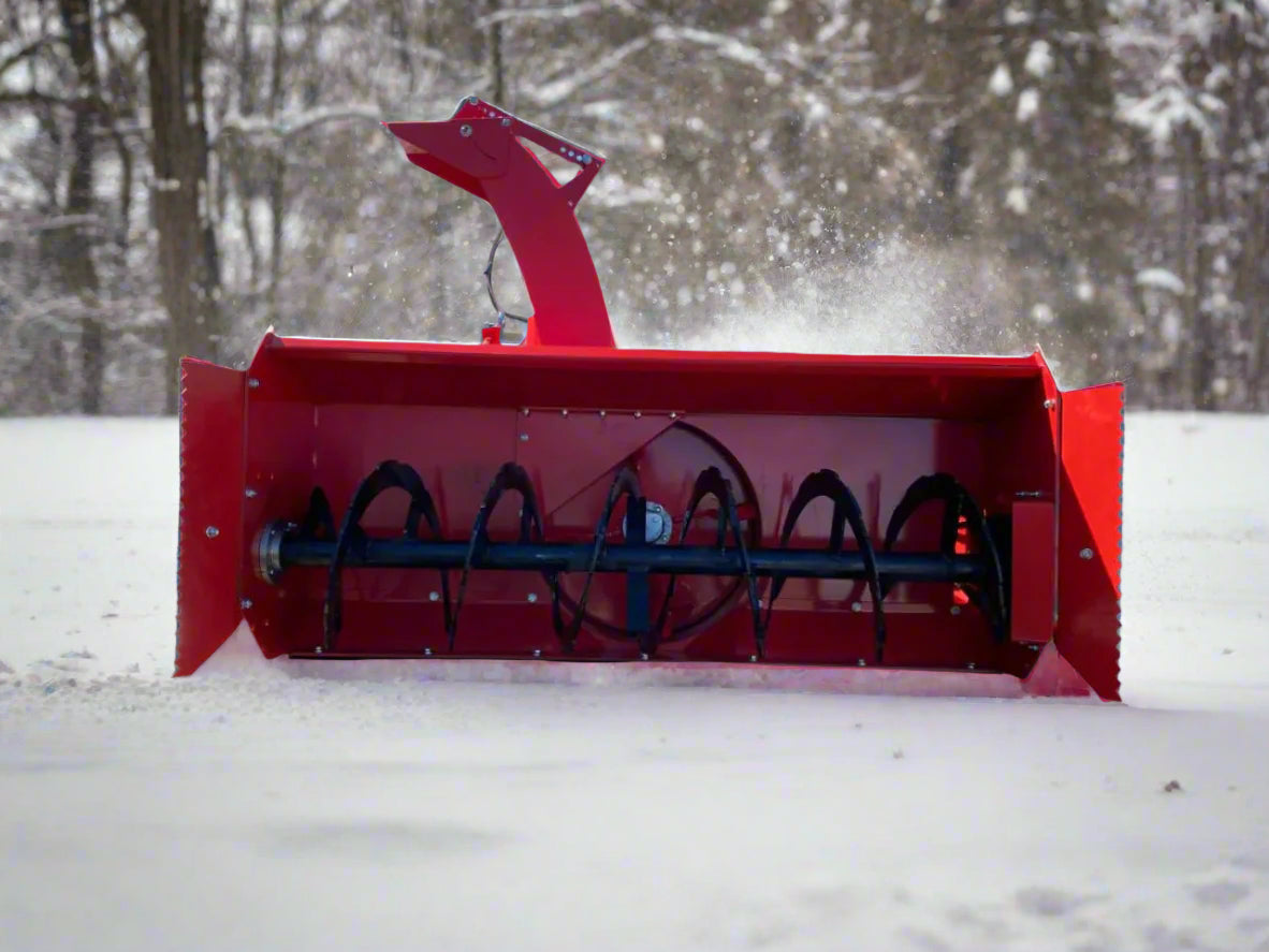 Extreme-duty red snow blower attachment for skid steer – front view

Hydraulic chute adjustment system on 84" snow blower model

72" skid steer snow blower attachment mounted for municipal use

Skid steer operator using snow blower in snowy mountain terrain

Rear hydraulic connection and chute control close-up on snow blower
