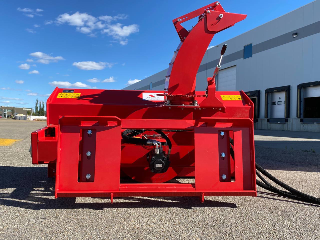 Extreme-duty red snow blower attachment for skid steer – front view

Hydraulic chute adjustment system on 84" snow blower model

72" skid steer snow blower attachment mounted for municipal use

Skid steer operator using snow blower in snowy mountain terrain

Rear hydraulic connection and chute control close-up on snow blower