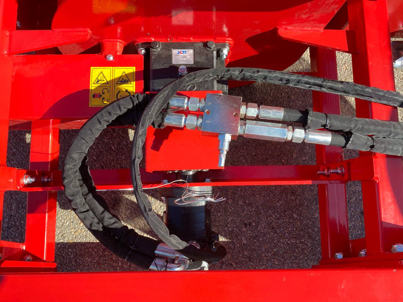 Extreme-duty red snow blower attachment for skid steer – front view

Hydraulic chute adjustment system on 84" snow blower model

72" skid steer snow blower attachment mounted for municipal use

Skid steer operator using snow blower in snowy mountain terrain

Rear hydraulic connection and chute control close-up on snow blower