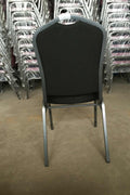 Stackable Banquet Chair – Black Dot Upholstery – Angled Front

Banquet Chairs in Row – Side View

Black Event Chairs in Use at Corporate Event

Commercial Banquet Seating – Stackable Design