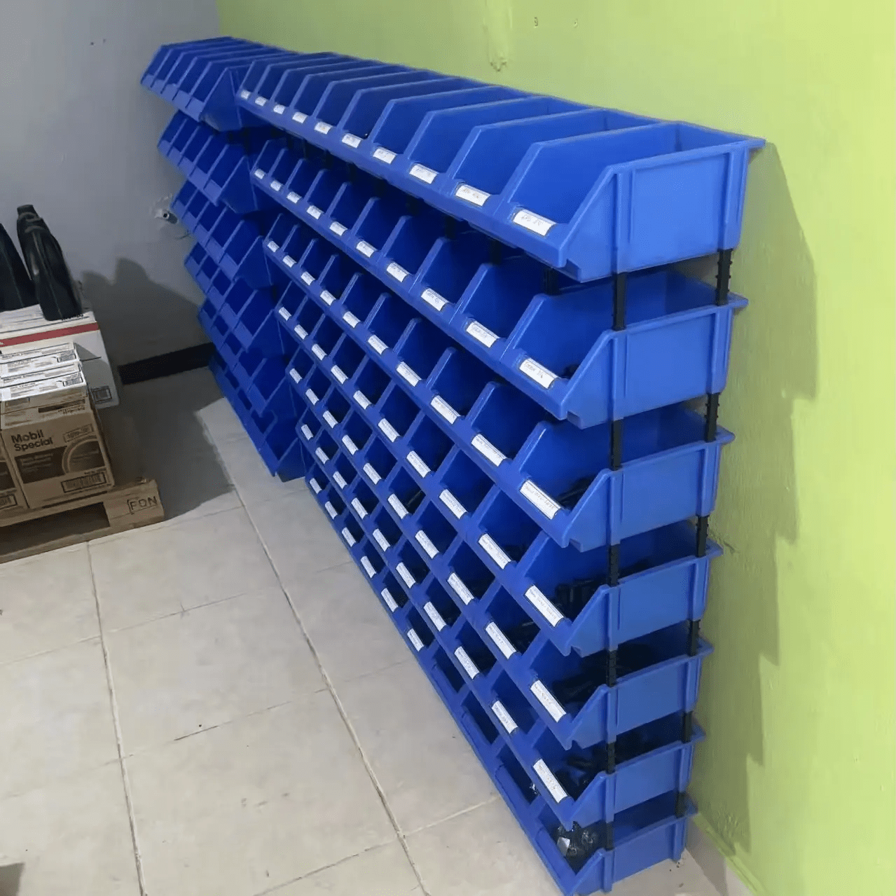 Stackable plastic bolt bins loaded with industrial tools and parts