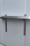 Stainless steel wall-mounted shelf front view

Close-up of shelf bracket and mounting

Side view of stainless steel shelf over prep station

Commercial wall shelf above kitchen counter

Single-tier wall shelf with polished finish