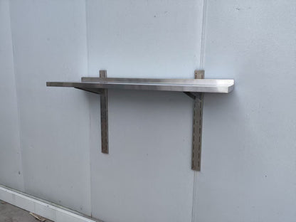 Stainless steel wall-mounted shelf front view

Close-up of shelf bracket and mounting

Side view of stainless steel shelf over prep station

Commercial wall shelf above kitchen counter

Single-tier wall shelf with polished finish