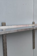 Stainless steel wall-mounted shelf front view

Close-up of shelf bracket and mounting

Side view of stainless steel shelf over prep station

Commercial wall shelf above kitchen counter

Single-tier wall shelf with polished finish