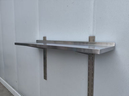Stainless steel wall-mounted shelf front view

Close-up of shelf bracket and mounting

Side view of stainless steel shelf over prep station

Commercial wall shelf above kitchen counter

Single-tier wall shelf with polished finish