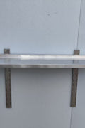 Stainless steel wall-mounted shelf front view

Close-up of shelf bracket and mounting

Side view of stainless steel shelf over prep station

Commercial wall shelf above kitchen counter

Single-tier wall shelf with polished finish