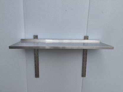 Stainless steel wall-mounted shelf front view

Close-up of shelf bracket and mounting

Side view of stainless steel shelf over prep station

Commercial wall shelf above kitchen counter

Single-tier wall shelf with polished finish