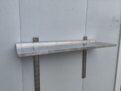 Stainless steel wall-mounted shelf front view

Close-up of shelf bracket and mounting

Side view of stainless steel shelf over prep station

Commercial wall shelf above kitchen counter

Single-tier wall shelf with polished finish