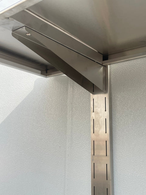 Stainless steel wall-mounted shelf front view

Close-up of shelf bracket and mounting

Side view of stainless steel shelf over prep station

Commercial wall shelf above kitchen counter

Single-tier wall shelf with polished finish