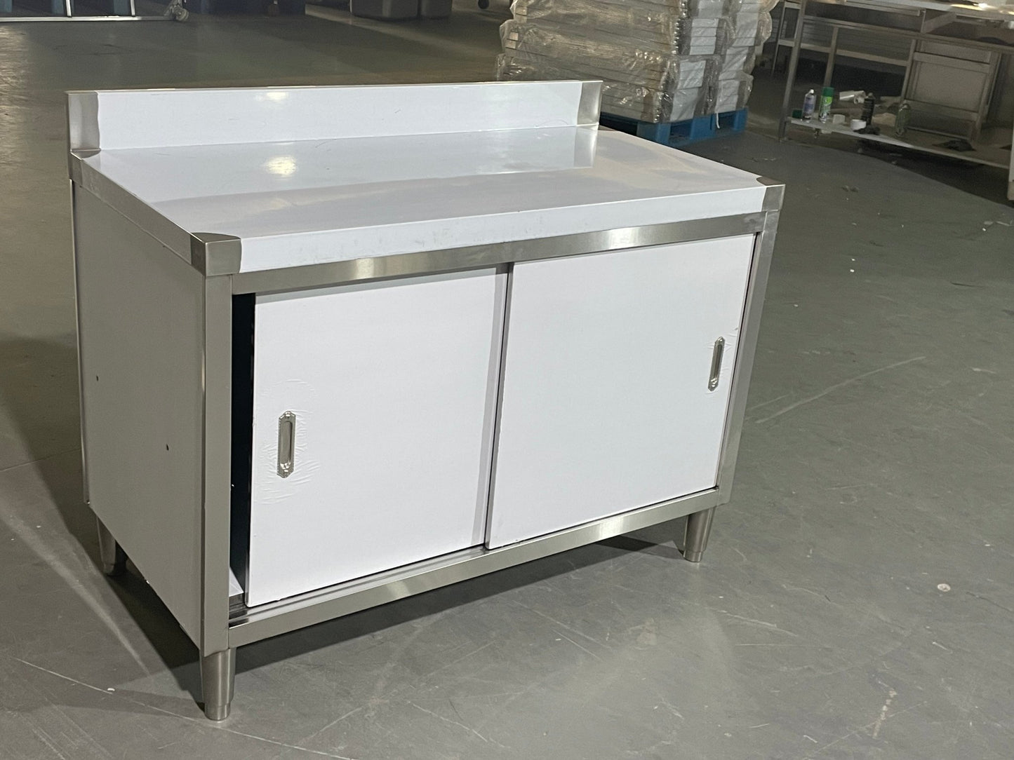 Stainless steel workbench with sliding doors front view

Restaurant prep table with built-in storage

Commercial kitchen stainless steel workbench

Side view of sliding door stainless work table

Heavy-duty garage workbench with stainless cabinet