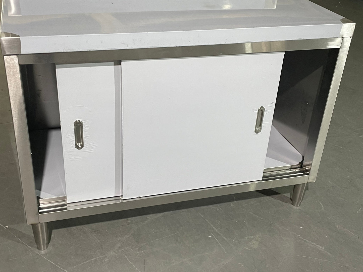 Stainless steel workbench with sliding doors front view

Restaurant prep table with built-in storage

Commercial kitchen stainless steel workbench

Side view of sliding door stainless work table

Heavy-duty garage workbench with stainless cabinet
