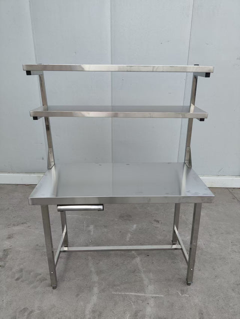 Stainless steel prep table with integrated overshelf – front view

Commercial-grade kitchen work table with upper storage

1200mm stainless prep station with dual-tier design

Heavy-duty stainless kitchen table – side angle

Restaurant overshelf prep table – silver finish

