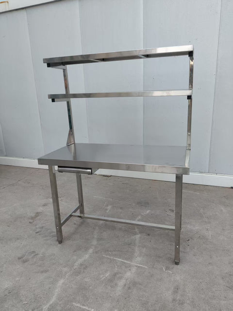 Stainless steel prep table with integrated overshelf – front view

Commercial-grade kitchen work table with upper storage

1200mm stainless prep station with dual-tier design

Heavy-duty stainless kitchen table – side angle

Restaurant overshelf prep table – silver finish


