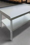 Stainless steel work table with 2-inch splash guard for kitchens
Commercial kitchen prep table with adjustable undershelf
Heavy-duty stainless table with galvanized legs and splash protection