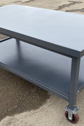 Steel Rolling Tool Table with Two Layers and Locking Casters – TC025M

Mobile Workbench with Gray Finish in Garage Setup

Heavy-Duty 2-Tier Steel Workstation for Industrial Use

Tool Table with Smooth-Rolling Wheels and Shelf Storage

Front Angle of Steel Workbench with Lower Shelf and Locking Wheels

Industrial Workshop Setup Featuring TC025M Rolling Bench

Side View of Assembled Rolling Work Table in Gray Metal