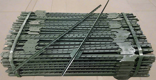 Stacked steel T-post fencing stakes with welded anchor plates for livestock and garden use