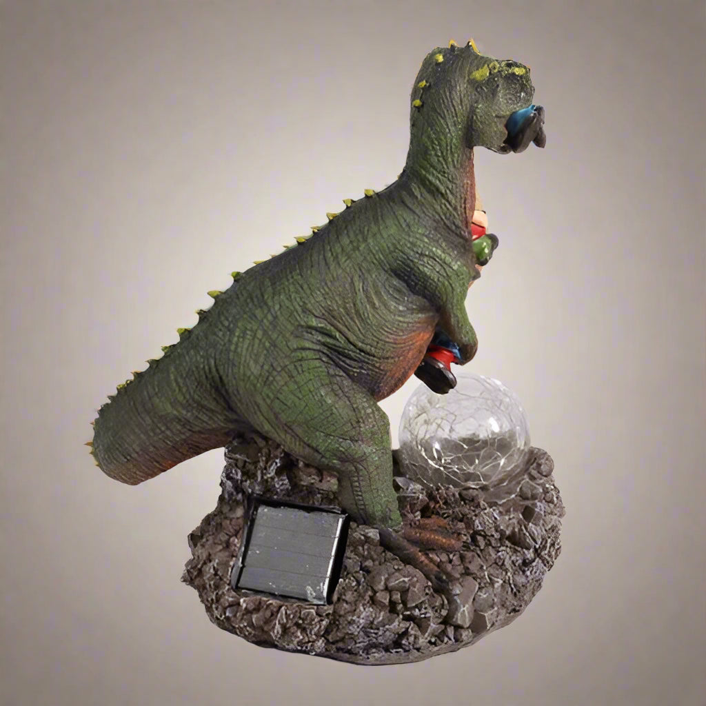 Funny dinosaur garden gnome massacre solar LED light
T-Rex devouring gnomes solar statue for garden decor
Outdoor dinosaur light with solar-powered LED illumination