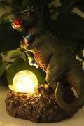Funny dinosaur garden gnome massacre solar LED light
T-Rex devouring gnomes solar statue for garden decor
Outdoor dinosaur light with solar-powered LED illumination