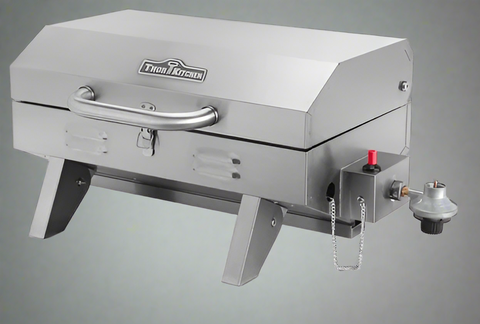 Compact stainless steel propane BBQ grill with lid closed