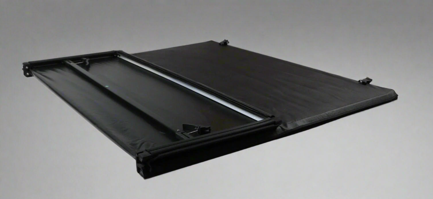 Tri-fold soft tonneau cover installed on Ford F-150 6.5 ft bed
Roll-up tonneau cover for 2009–2020 Ford truck bed
Weatherproof vinyl truck bed cover with clamp system
Tonneau cover folded up showing bed access
Side view of tri-fold tonneau cover on Ford F-150