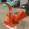 Front view of BX42T 3-point wood chipper attachment

Side profile showing 25" chipping disk on BX42T

Close-up of chipper blades and discharge chute

BX42T wood chipper connected to tractor PTO