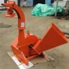 Front view of BX42T 3-point wood chipper attachment

Side profile showing 25" chipping disk on BX42T

Close-up of chipper blades and discharge chute

BX42T wood chipper connected to tractor PTO
