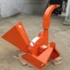 Front view of BX42T 3-point wood chipper attachment

Side profile showing 25" chipping disk on BX42T

Close-up of chipper blades and discharge chute

BX42T wood chipper connected to tractor PTO