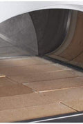 Pizza cooking inside dual-fuel oven outdoors. Full pizza oven on patio with wood and gas tank connected