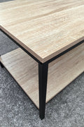 Minimalist wood grain coffee table in a living room setting
Side view of coffee table with black metal frame
Open shelf coffee table for modern homes
Neutral-toned coffee table with sturdy build
Lifestyle photo of coa ffee table with décor accessories