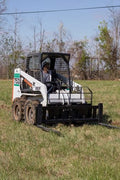 XL pallet fork frame with 2-inch receiver for skid steer – 5000 lb rated
Heavy-duty 72-inch skid steer pallet fork frame with headache rack
Skid steer fork frame in field with trailer hitch and fork slots
Compact 60" pallet fork frame – skid steer attachment
Slotted carriage for Class II pallet forks on steel frame