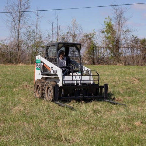 XL pallet fork frame with 2-inch receiver for skid steer – 5000 lb rated
Heavy-duty 72-inch skid steer pallet fork frame with headache rack
Skid steer fork frame in field with trailer hitch and fork slots
Compact 60" pallet fork frame – skid steer attachment
Slotted carriage for Class II pallet forks on steel frame