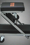 “Folding mechanic creeper seat with wheels and padding”

“2-in-1 creeper and stool in folded position”

“Padded garage creeper stool with Z-frame design”

“Mechanic rolling seat used under car in garage”

“Close-up of caster wheels and vinyl seat cushion”
