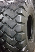 Heavy-duty E-3/L3 bias ply loader tire on warehouse floor

Rock lug pattern close-up for traction

20.5-25 loader tire tread and sidewall view

Mining OTR tire mounted on equipment

Rugged loader tire for industrial applications