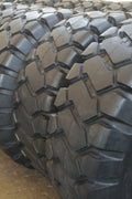 Heavy-duty E-3/L3 bias ply loader tire on warehouse floor

Rock lug pattern close-up for traction

20.5-25 loader tire tread and sidewall view

Mining OTR tire mounted on equipment

Rugged loader tire for industrial applications