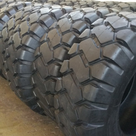Heavy-duty E-3/L3 bias ply loader tire on warehouse floor

Rock lug pattern close-up for traction

20.5-25 loader tire tread and sidewall view

Mining OTR tire mounted on equipment

Rugged loader tire for industrial applications