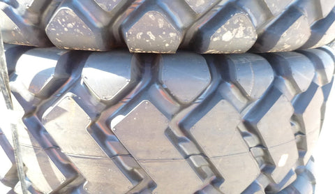 Heavy-duty E-3/L3 bias ply loader tire on warehouse floor

Rock lug pattern close-up for traction

20.5-25 loader tire tread and sidewall view

Mining OTR tire mounted on equipment

Rugged loader tire for industrial applications