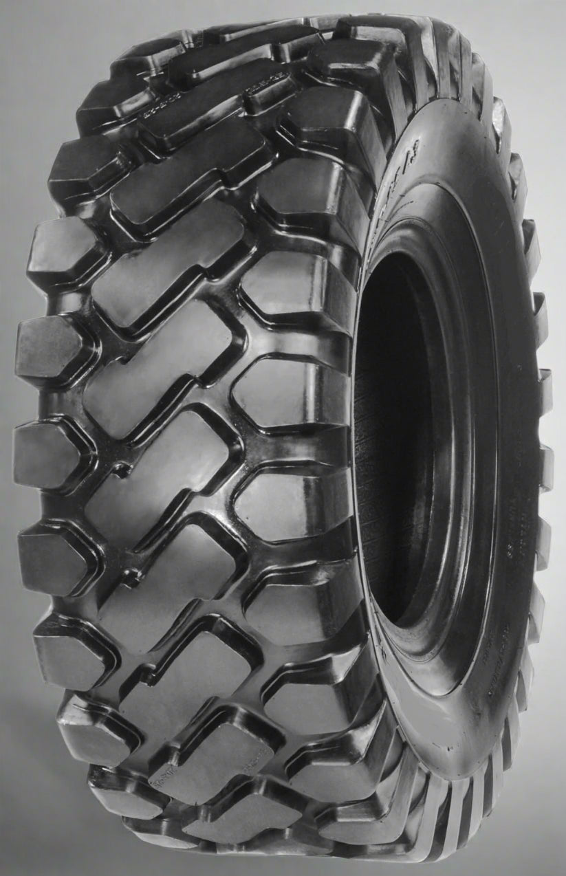 Heavy-duty E-3/L3 bias ply loader tire on warehouse floor

Rock lug pattern close-up for traction

20.5-25 loader tire tread and sidewall view

Mining OTR tire mounted on equipment

Rugged loader tire for industrial applications