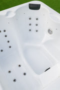 Three seat arrangement in compact outdoor spa with jets