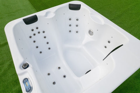 Three seat arrangement in compact outdoor spa with jets