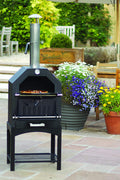 "Stainless steel outdoor pizza oven with chimney and stone insert"

"Dual-fuel pizza oven setup with wood and gas burners"

"Outdoor stainless pizza oven in backyard setting"

"Compact portable pizza oven on patio table"

"Fully cooked pizza inside stainless oven"